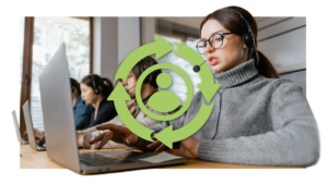Female telemarketer talking into headset while using laptop